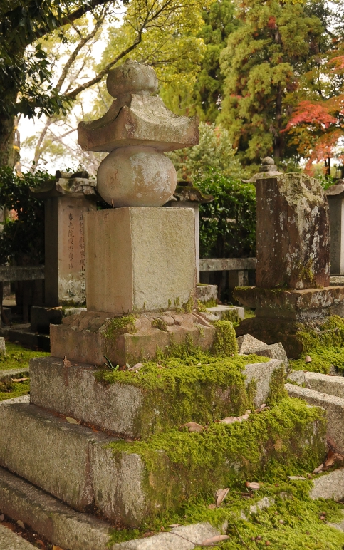 old tomb with moss at kurodani graveyard