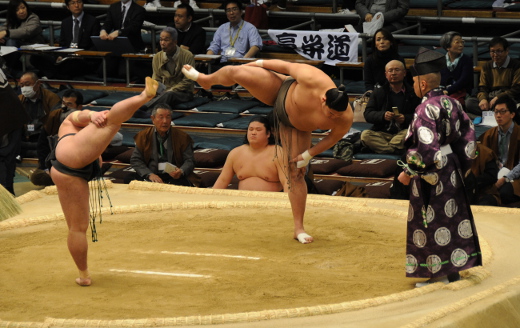 Two sumo wrestlers preparing for their bout