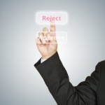 A Man presses a "reject" buttion