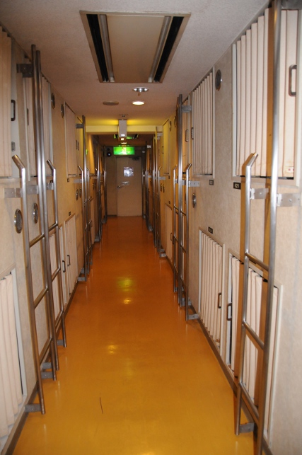 a corridor with 34 capsule "rooms"