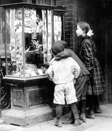 children looking at a store window with Christmas cards, 1910