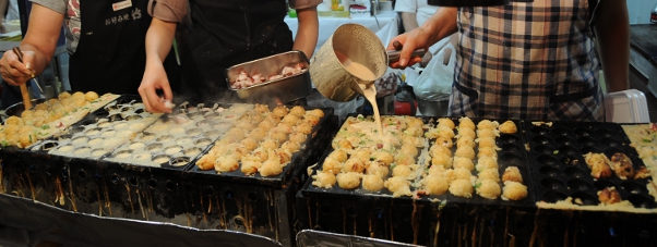 street vendors making takoyaki