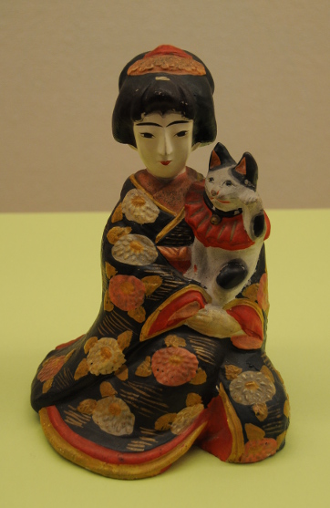 geisha figurine with maneki neko